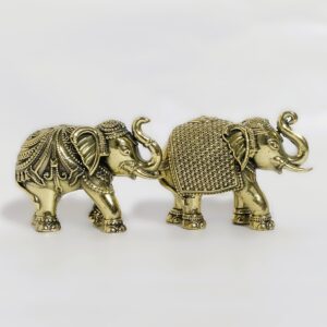 Side view of antique brass elephants pair