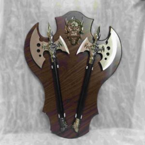antique warrior axes on wooden plaque